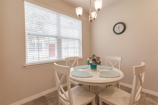 dining area featuring a chandelier and tile patterned flooring