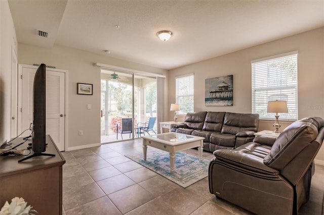 living room with light tile patterned flooring and a wealth of natural light