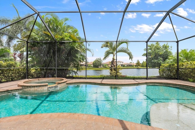 view of swimming pool featuring glass enclosure, a pool with connected hot tub, and a water view