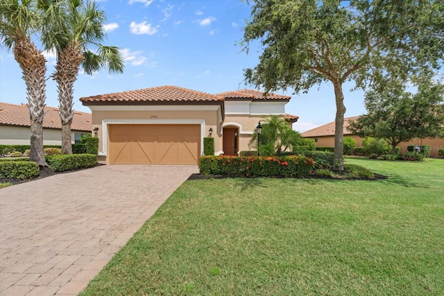 mediterranean / spanish-style home with a garage and a front lawn