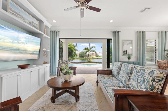 tiled living room with crown molding and ceiling fan