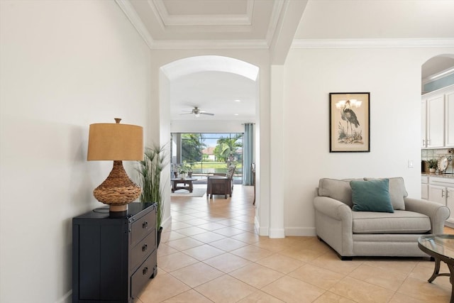 interior space with ornamental molding, light tile patterned floors, and ceiling fan