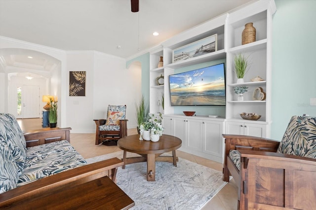 tiled living room with crown molding and ceiling fan