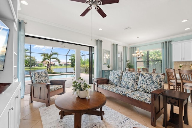 tiled living room featuring crown molding, plenty of natural light, and ceiling fan with notable chandelier