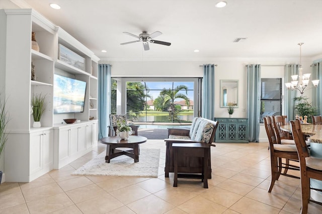 living room featuring ceiling fan with notable chandelier, crown molding, and light tile patterned floors