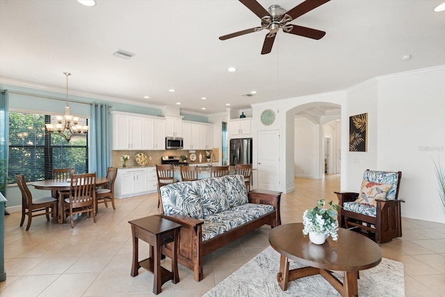 tiled living room featuring ceiling fan with notable chandelier, ornamental molding, and sink