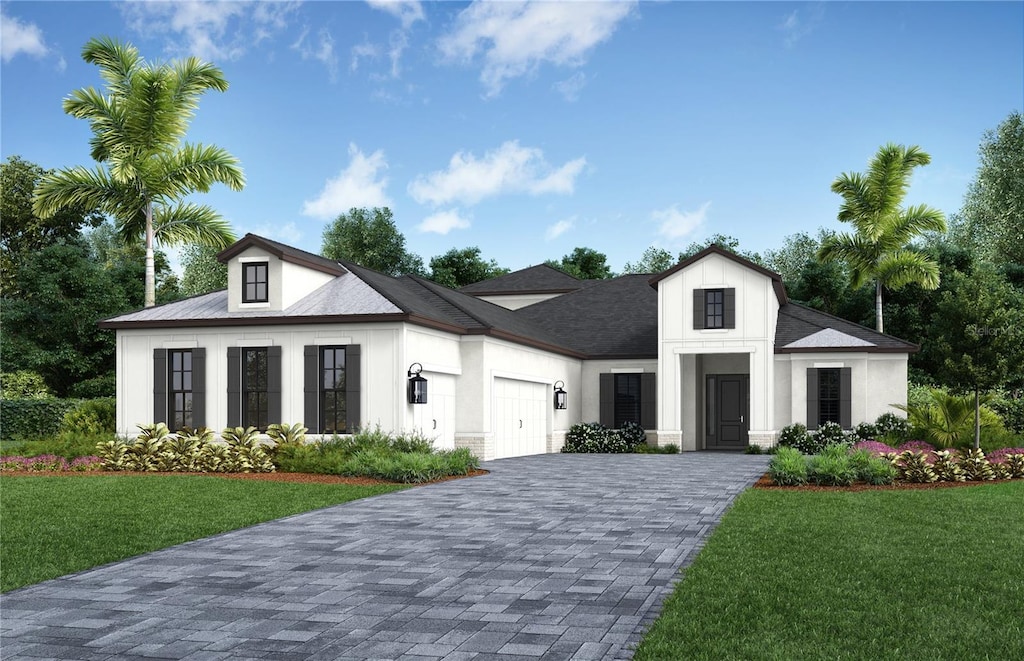 view of front of house with a garage and a front lawn