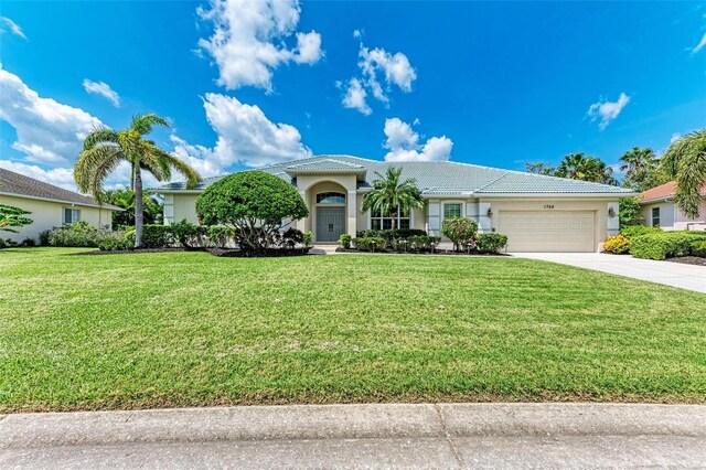 view of front facade with a front lawn and a garage