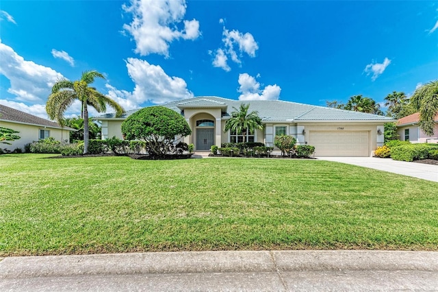 view of front of home featuring a garage and a front lawn