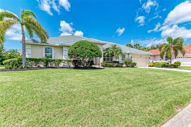 single story home with a garage and a front lawn