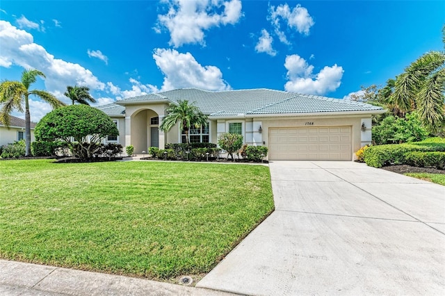 view of front of home with a front yard and a garage