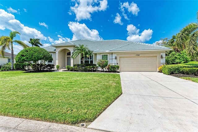 view of front of house featuring a garage and a front lawn