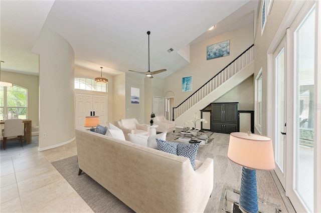 tiled living room with high vaulted ceiling