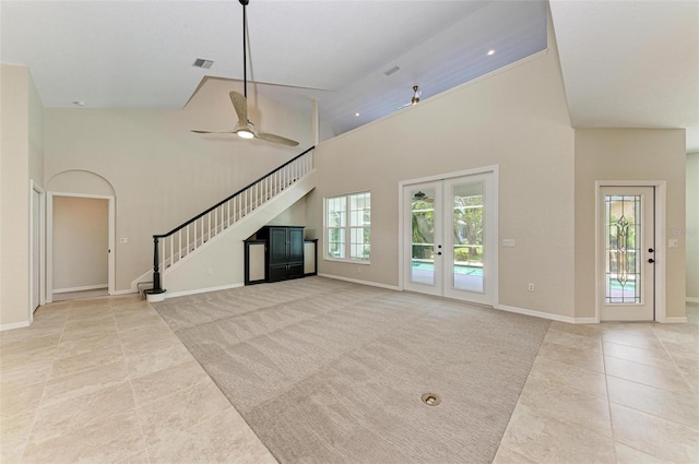 unfurnished living room featuring ceiling fan, high vaulted ceiling, and light tile patterned floors