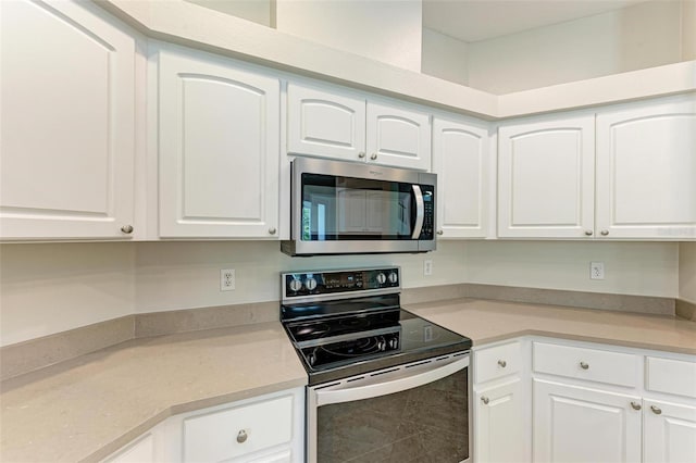 kitchen with white cabinetry and appliances with stainless steel finishes