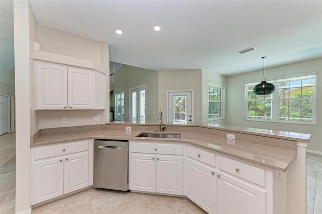 kitchen with light tile patterned floors, stainless steel dishwasher, sink, and pendant lighting