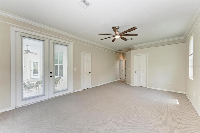 carpeted empty room with ornamental molding, french doors, and ceiling fan