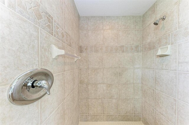 bathroom with a tile shower