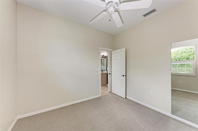 unfurnished room featuring ceiling fan and light carpet