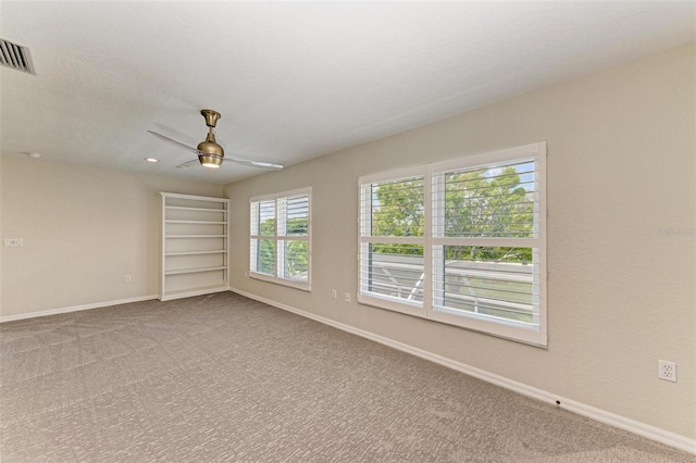 carpeted spare room with ceiling fan and a textured ceiling