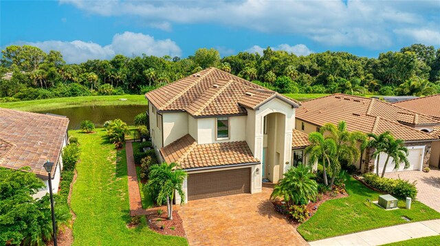 mediterranean / spanish-style house with a front lawn and a garage