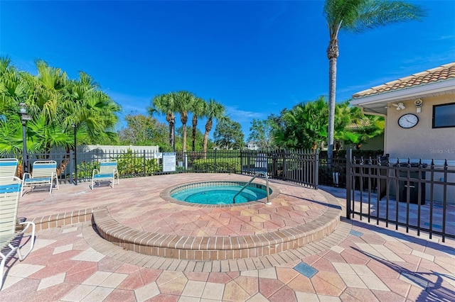 view of pool featuring a hot tub and a patio