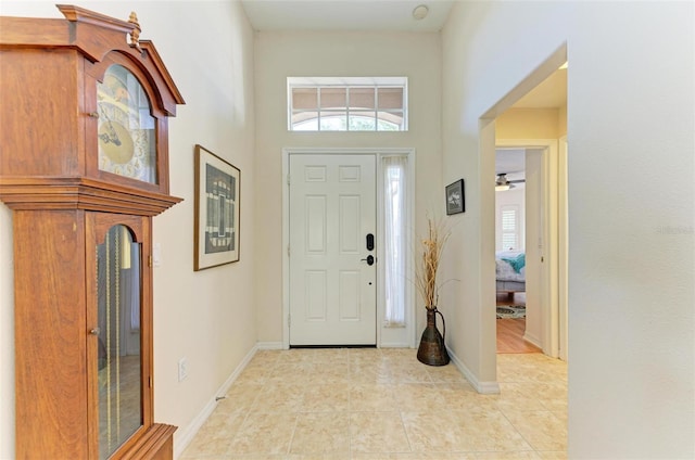 foyer featuring a high ceiling and ceiling fan