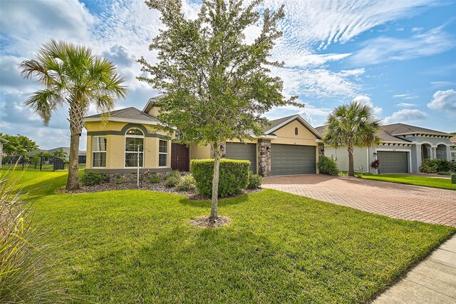 view of front of property with a front lawn and a garage