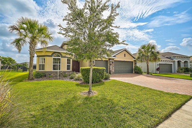 view of front of house with a front lawn and a garage