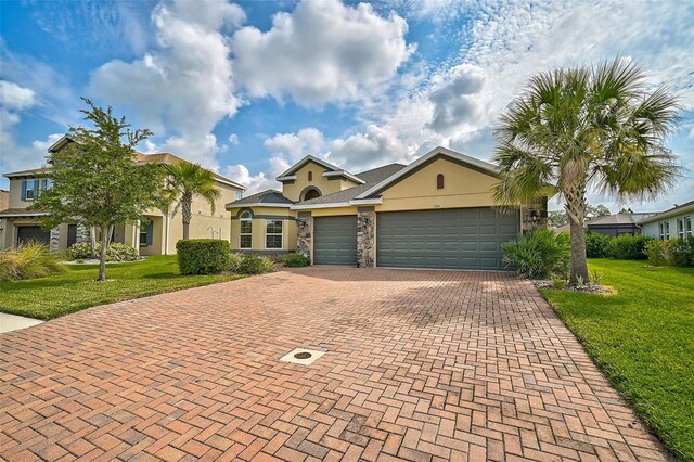 view of front of property with a front yard and a garage