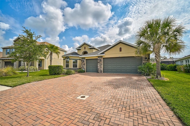 view of front of home featuring a garage and a front lawn