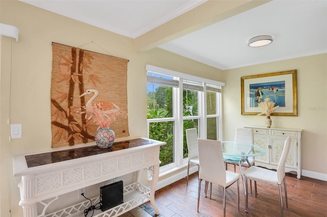 dining space featuring beamed ceiling, ornamental molding, and hardwood / wood-style floors