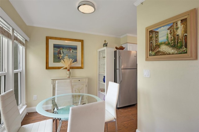 dining room with crown molding and wood-type flooring