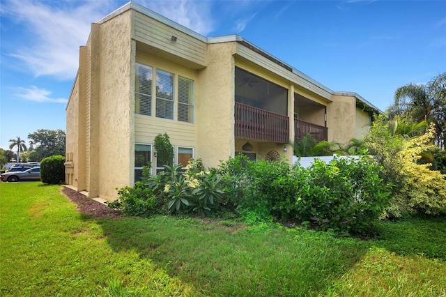 view of side of home with a yard