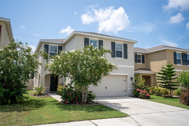 view of front of property featuring a garage, driveway, a front lawn, and stucco siding