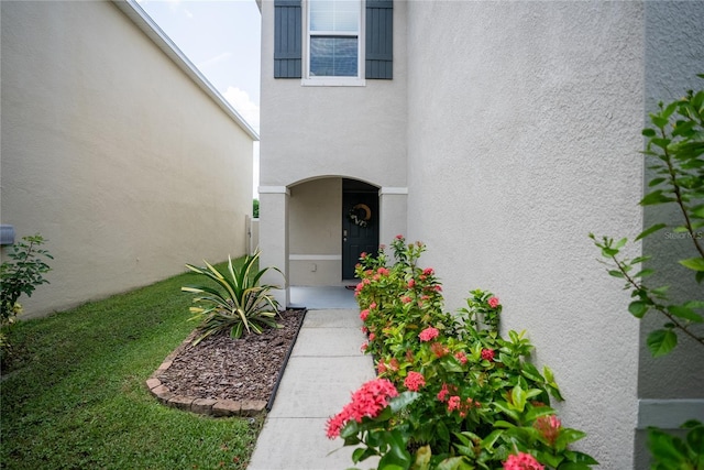 entrance to property with stucco siding