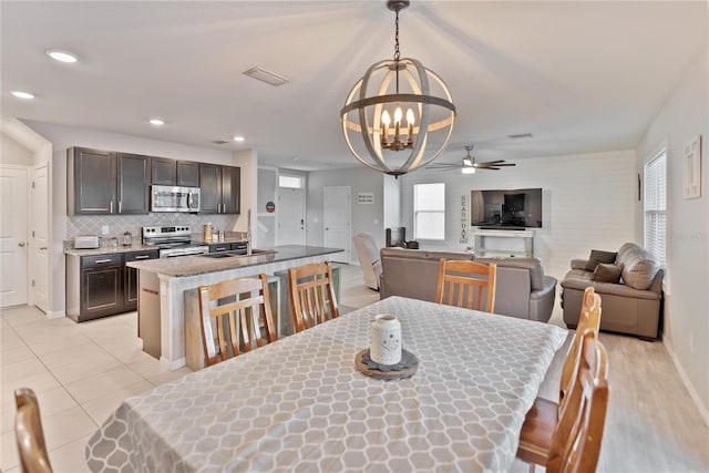 dining space with baseboards, a wealth of natural light, visible vents, and recessed lighting