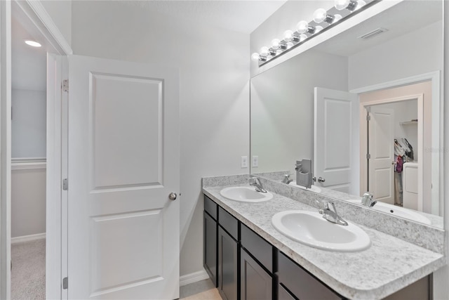 full bathroom with double vanity, visible vents, and a sink