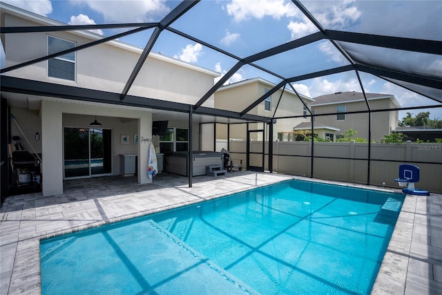 view of swimming pool featuring a hot tub, a fenced in pool, a patio, ceiling fan, and a lanai