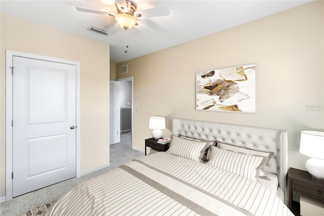 carpeted bedroom featuring visible vents, ceiling fan, and baseboards