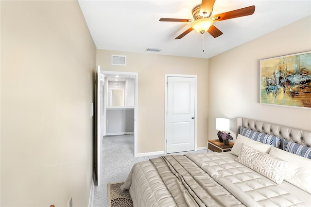 bedroom with light colored carpet, ceiling fan, visible vents, and baseboards