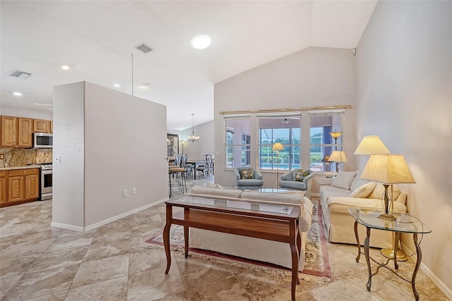 living room with lofted ceiling and an inviting chandelier