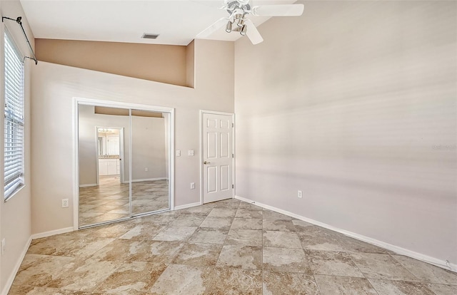 unfurnished room with ceiling fan and lofted ceiling