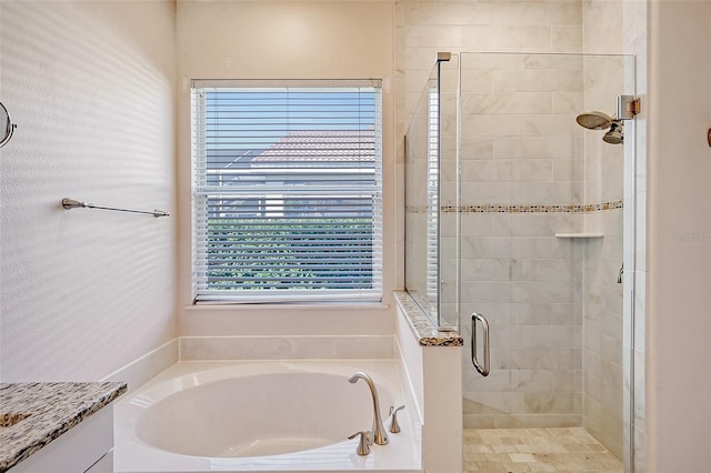 bathroom featuring plus walk in shower and vanity