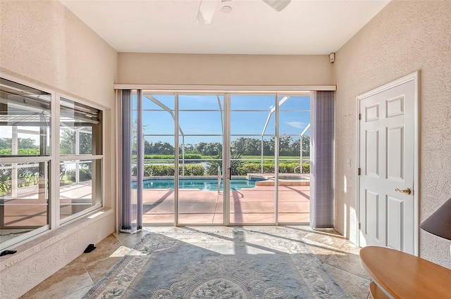 doorway featuring ceiling fan