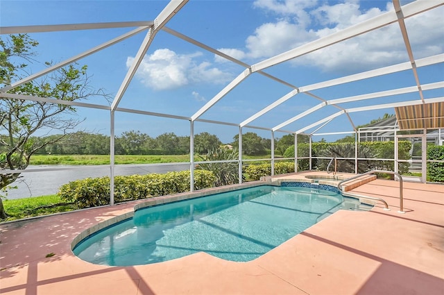 view of pool with an in ground hot tub, a patio, and glass enclosure