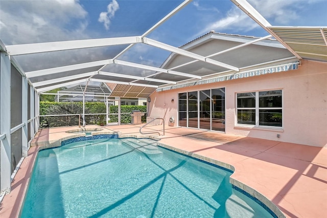 view of swimming pool with a lanai, a patio area, and an in ground hot tub