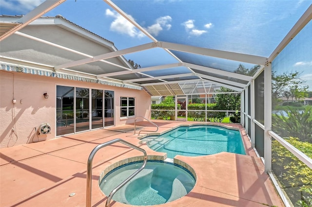 view of pool featuring glass enclosure, an in ground hot tub, and a patio