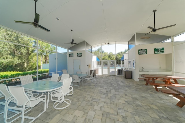 view of patio / terrace with ceiling fan, a pool, and sink