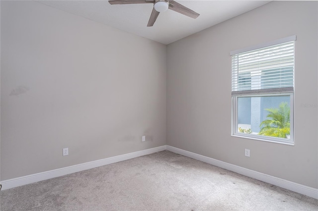 carpeted empty room with plenty of natural light and ceiling fan